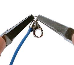 Pliers adding a clasp to the jump ring